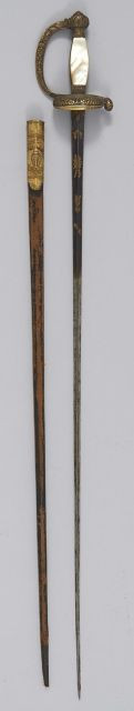 Épée de l'Institut. Fusée à plaquettes de nacre. Monture en laiton ciselé doré. Garde à une branche. Clavier à la toile d'araignée. ...