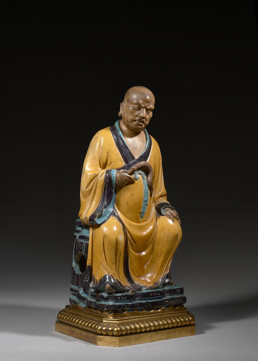 IMPORTANTE STATUE DE LUOHAN EN GRÈS ÉMAILLÉ JAUNE, TURQUOISE ET AUBERGINE, Chine, dynastie Ming (1368-1644)