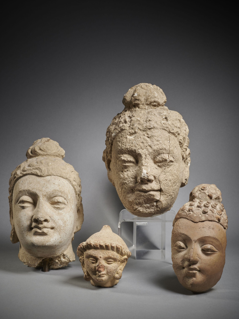 ENSEMBLE DE TROIS TÊTES DE BOUDDHA ET D'UN PRÉPOSÉ  Art du Gandhara, Pakistan ou Afghanistan, IIe-IVe siècle